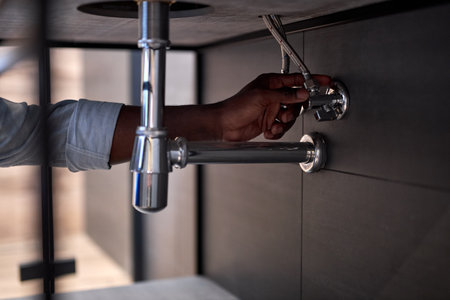 Handsome Hardworking Plumber Installing The Sink In Bathroom Close-up Photo, Cropped Black Man. Guy...
