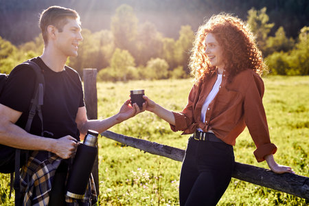 Beautiful caucasian couple spending time in nature. Visiting countryside,active tourism. Hiking in...