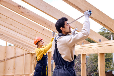 Friendly caucasian Contractors measuring the size and length of wooden beam, team of man and woman...
