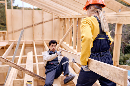 Two Specialists Measuring Examining The Size Of Wooden Beam During Cottage Building. Real Estate...