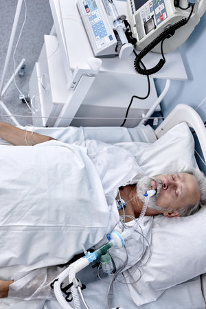aged caucasian european man suffering from coronavirus or covid-19. bedridden male patient on...