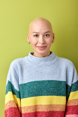 Portrait of positive smiling bald female in casual wear posing looking at camera. Attractive lady with allopecia enjoy life, having good mood, no reason to feel bad. copy spaceの写真素材