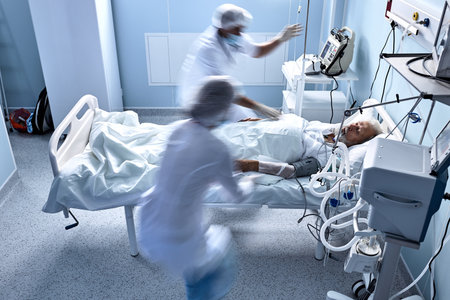 unrecognizable doctors nurses save a patient from death lying on bed in hospital, the patients heart rate slows down, at day time. senior man suffering from disease, heart attack, pneumoniaの写真素材