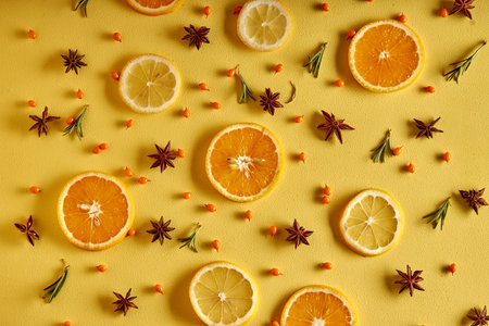 Slices of fresh fruits lemons and oranges Isolated on yellow Background Top View. Advertising, Cuisine Menu, Food. copy spaceの写真素材