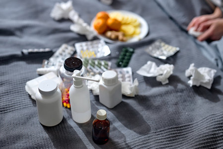 pile of different vitamins, pills, medicine, antiviral antibiotics antipyretic painkillers are on bed, close up cropped shotの写真素材