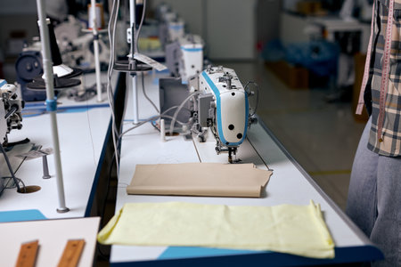 empty room, clothing manufacturing factory. sewing department with modern sewing machine, tailors sewing studio, sewing school, clothing manufacturing, sewing industry. no peopleの写真素材