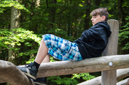 Boy relaxing in the forestの写真素材