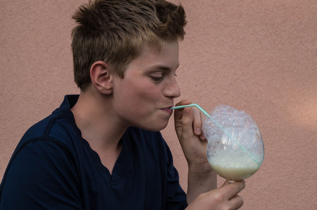 Boy with a glass of milkの写真素材