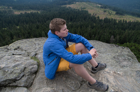 Young man on the mountain topの写真素材