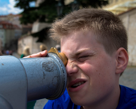 Young man with telescopeの写真素材