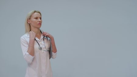 serious Young female doctor in white room writingの写真素材