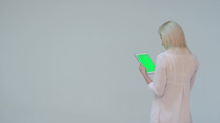 Doctor pressing the green screen of a tablet computer againstの写真素材
