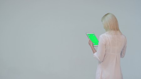 Doctor pressing the green screen of a tablet computer againstの写真素材