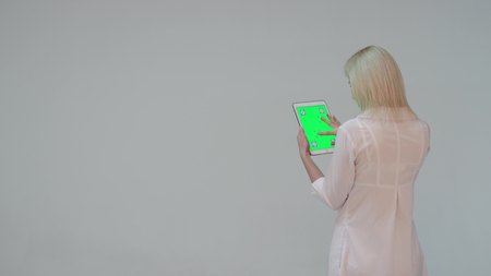 Doctor pressing the green screen of a tablet computerの写真素材