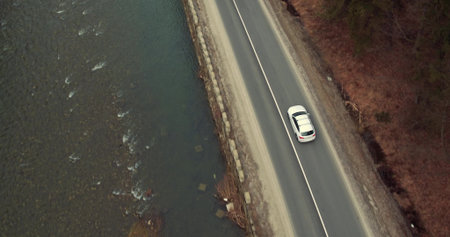 White Car Goes on the Mountains Road