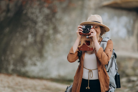 Portrait Teenage girl posing for camera taking photo with rocksの写真素材