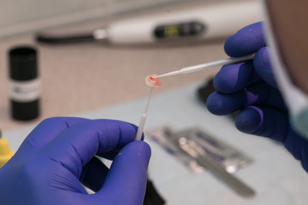 dentist is holding tweezers for dental ceramic veneers and crowns