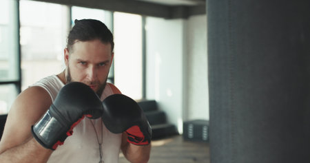 Sports and people, young male athlete training in boxing gym