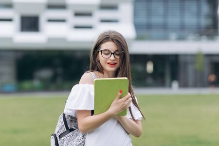 Woman using white tablet device computer. Touchscreen outdoors.の写真素材
