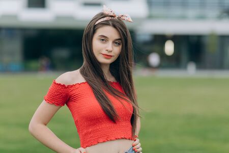 Casual young woman looking at camera. Caucasian female university student looking at camera smiling happy.の写真素材
