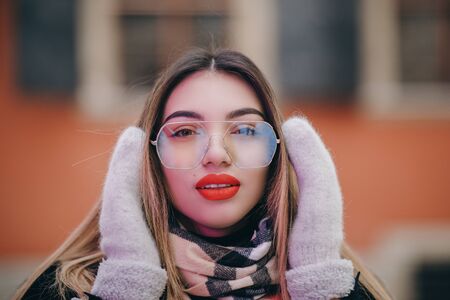 Outdoor Close Up Portrait of Young Happy Smiling Girl with Red Lips, wearing french style, Posing in Street of European City. Winter fashion, Christmas holidaysの写真素材