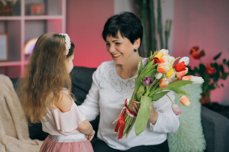 Hugging happy family. Happy Mothers Day. Little daughter congratulates her mother on Mothers Day