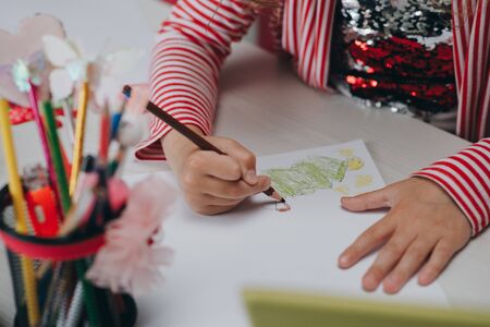 Hands of kid who is involved by drawing. Creative hobby, lifestyle drawing. Artist concept. Talented Innovative Female Artist Draws with Her Handsの写真素材