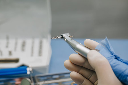Dentist doctor hand holding dentist tools in Dentist Clinic.