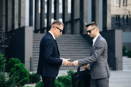 Two unrecognized business partners shaking hands. Colleagues just made good deal. Business...