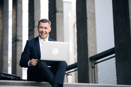 Male professional communicating by videoconference. Smiling business man talking on video conference...
