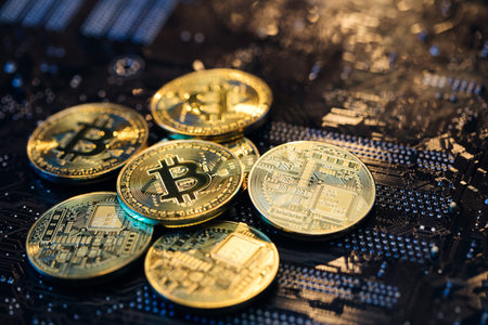 Blockchain technology, bitcoin mining. Close up shot of Gold Bitcoins coins isolated on motherboard...