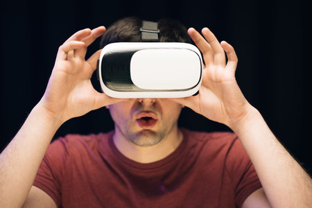 Handsome man wearing virtual reality headset. Augmented Reality. Man using modern 3D vr glasses...
