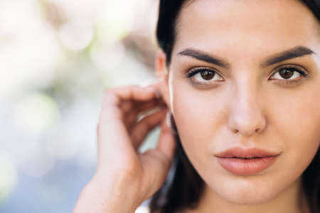 Close up of Womans Face, Girl with her Beautiful Brown Eyes. Natural Beauty Face Woman. Gorgeous Woman with Attractive Appearance. Gorgeous Dark Haired Hispanic Woman.の写真素材