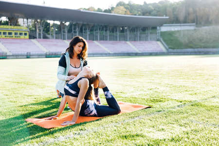 Doctor Works on Specific Muscle Groups or Joints. Young girl doing exercises under physiotherapist supervision. Patient Uses Physical Therapy to Recover from Surgery and Increase Mobilityの写真素材