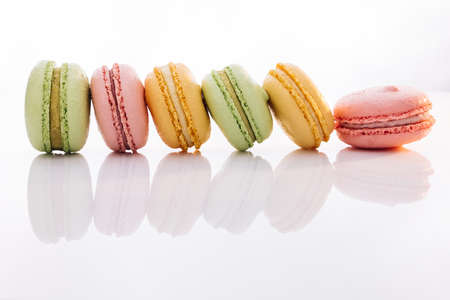 Colorful macarons dessert. French macarons on white background. Different colorful macaroon. Tasty sweet color macaronの写真素材