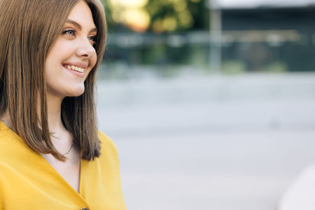 Face attractive brunette woman at sunset smiling beautiful around blue eyes. Stand outdoor relax....