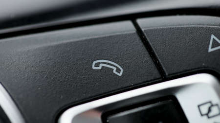 Bluetooth buttons located on the steering wheel of a car to talk over the phone hands free. Button car cell phone.の写真素材