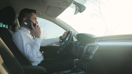 Businessman is talking on his Smart Phone while traveling in Business Class Car. Successful...