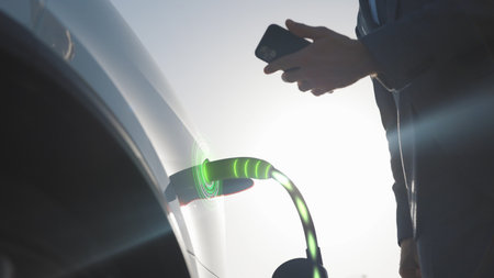 Animation of Businessman attaching power cable to electric car. Electric vehicle recharging battery...
