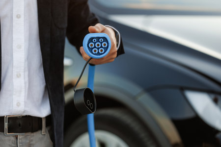 Fast charging socket type 2 combo electric car. DC - CCS type 2 EV charging connector at EV car. Eco friendly alternative energy green environment. Type 2 CCS plug port cable on electric vehicleの写真素材