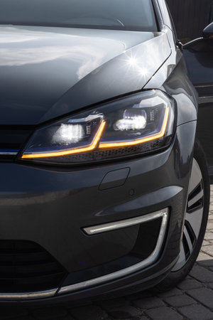 Car Front Full Led Light. Modern car headlamp flashing light with blinking on continuously indicator. Switched on led lights of luxury car. Car Blinker Lightの写真素材