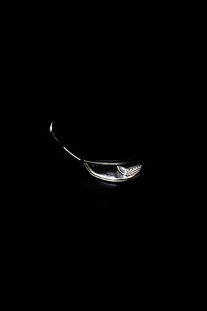 Switched on led matrix lights of luxury car. Car Blinker Light. Car front full led matrix IQ Light. Modern car headlamp flashing light with blinking on continuously indicatorの写真素材