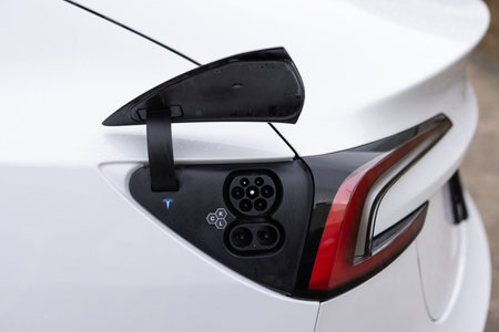 Lviv, Ukraine - March 23, 2024: New Tesla Model 3 highland electric car closeup of charging port....