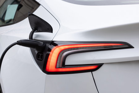 Electric car charging. Electric vehicle charging port plugging in car. Charging technology, Clean...