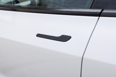 Exterior design of a new electric luxury car. Automatic opening of a car door without a key. Car door handle. Access button. Keyless entry car door handle with keyless go touch sensorの写真素材