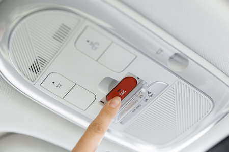 Finger pressing emergency sos button to contact with call center to ask for help after car accident....