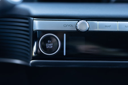 Pushing start stop Button to start keyless ignition hybrid car electro engine. Starting car engine....