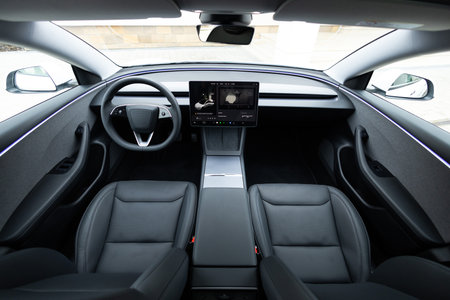 Lviv, Ukraine - March 23, 2024: Interior Tesla Model 3 highland electric car. Inside car interior with front leather seats, steering wheel, windows, console, electric buttons, digital speedometerのeditorial素材