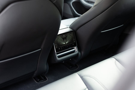 Lviv, Ukraine - March 23, 2024: White Tesla Model 3 highland electric car. Interior of prestige modern car. Back seats with display. Car insideのeditorial素材