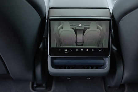 Lviv, Ukraine - March 23, 2024: Interior Tesla Model 3 highland electric car. Air conditioning of car on the climate control panel. Luxurious car air conditioner. Climate control dashboard displayのeditorial素材